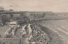 Load image into Gallery viewer, Vintage postcard of a beach scene with people and tents, likely from the early 20th century.
