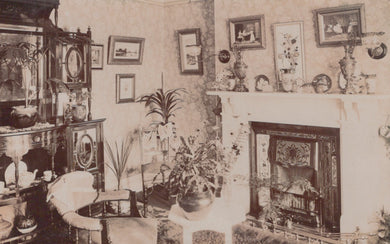 Vintage interior scene with a fireplace, furniture, and decorative items.