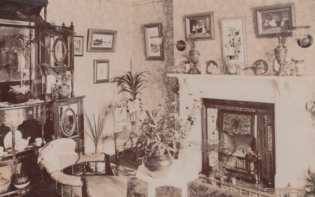 Vintage interior scene with a fireplace, furniture, and decorative items.