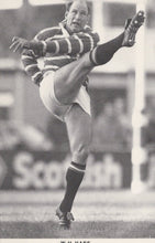Load image into Gallery viewer, Black and white photo of a rugby player in action on a field with &#39;Scottish&#39; branding.
