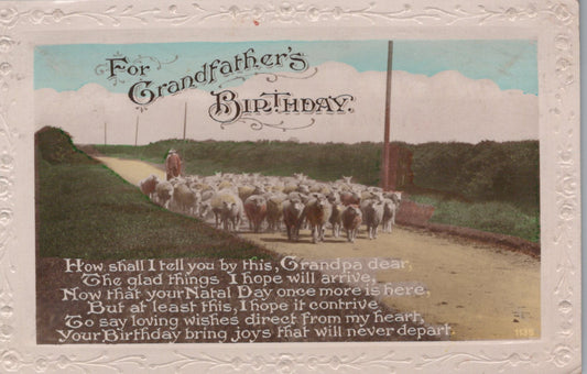 Vintage birthday card with a shepherd and sheep on a road, text overlay.