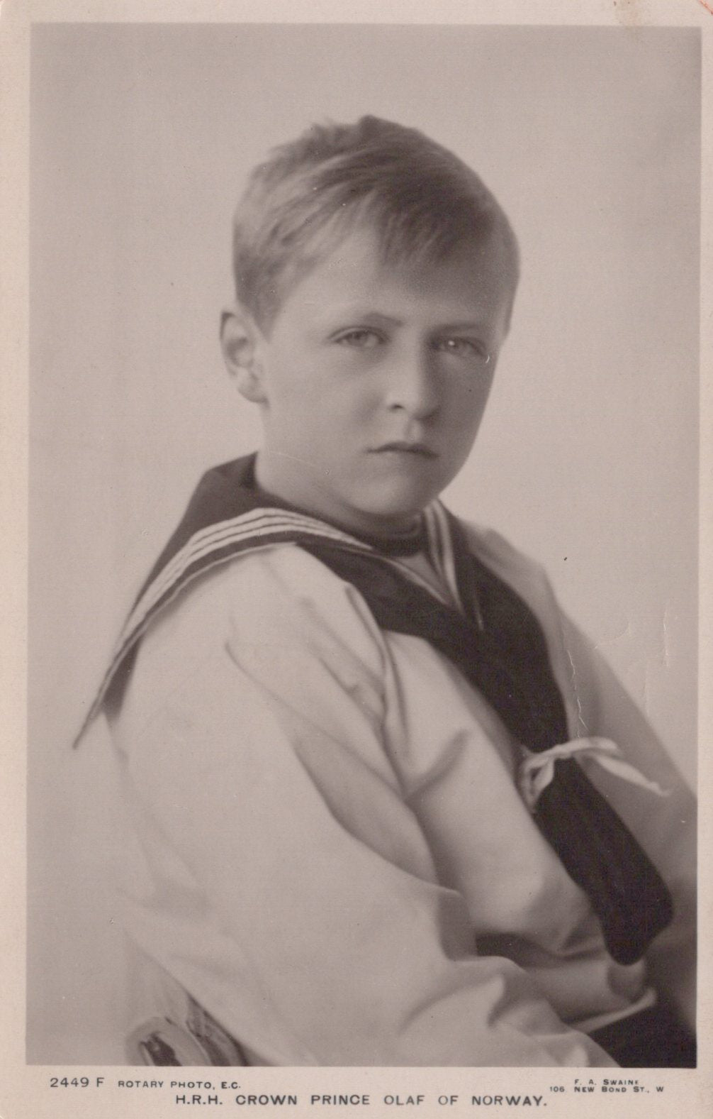 Vintage photograph of a young boy in a formal outfit with a sailor-style shirt and tie.