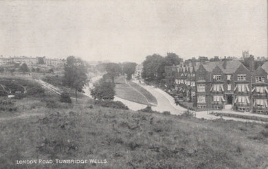 Vintage black and white photograph of a residential area with houses and a road.