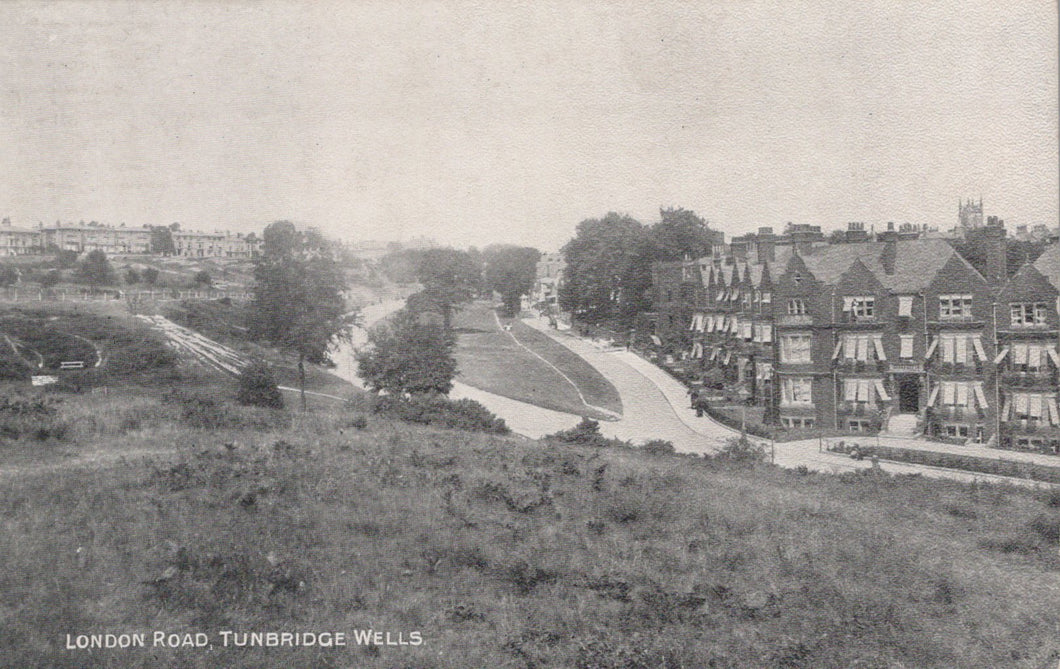 Vintage black and white photograph of a residential area with houses and a road.