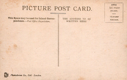 Vintage picture postcard with text and stamps on a beige background