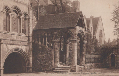 Historic stone building with arches and columns, likely a Norman structure, in a sepia tone.