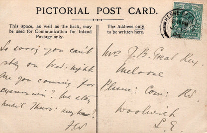 Vintage postcard with text and stamp, featuring a handwritten message.