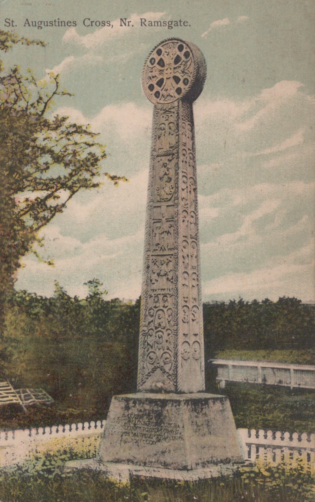 Stone monument with intricate design in a park-like setting