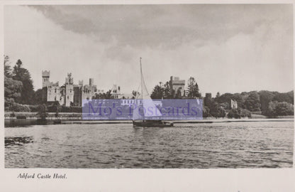 Vintage black and white photo of a castle by a body of water with 'Mo's Postcards' logo.