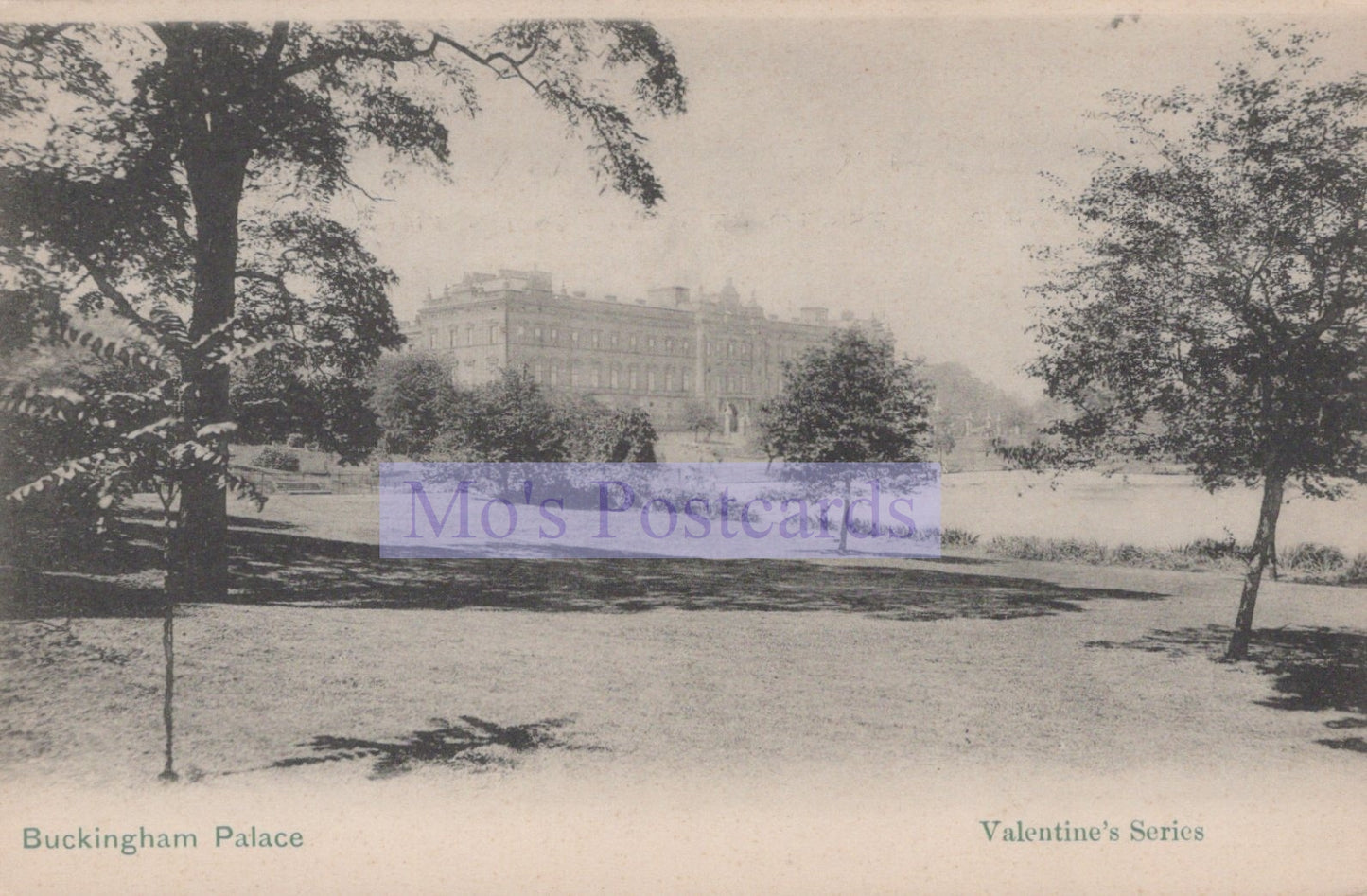 Vintage postcard of Buckingham Palace with trees and a lake