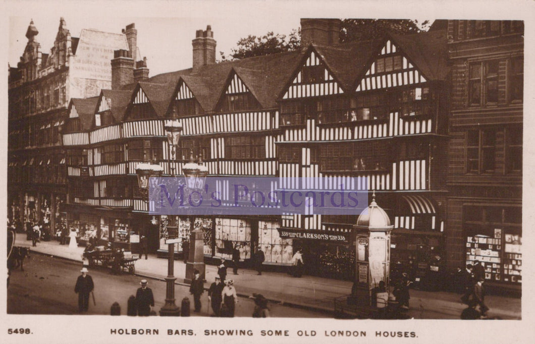 Vintage black and white photo of Holborn Bars with old London houses and a prominent sign.