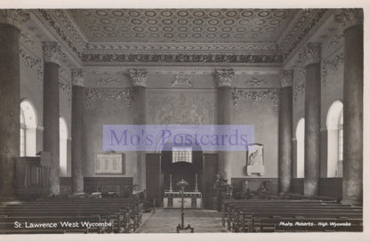 Interior of a church with pews and a pulpit, featuring decorative ceiling and walls.
