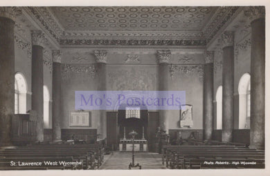Interior of a church with pews and a pulpit, featuring decorative ceiling and walls.