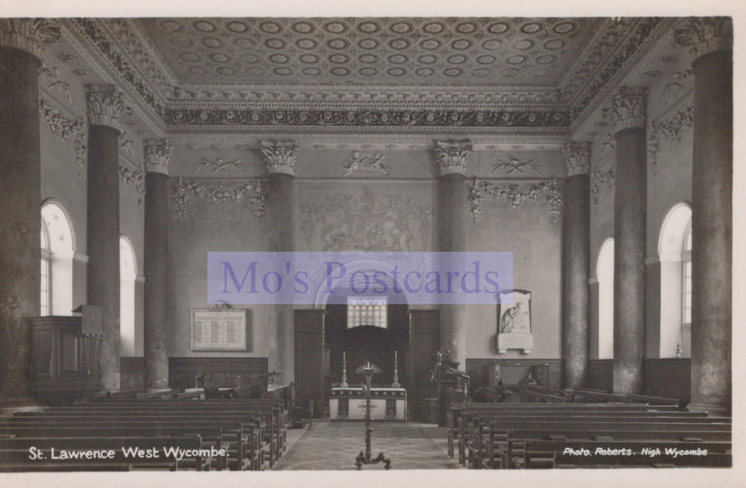 Interior of a church with pews and a pulpit, featuring decorative ceiling and walls.
