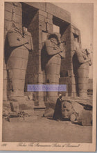 Load image into Gallery viewer, Vintage photograph of colossal statues at Ramesseum with a person for scale.
