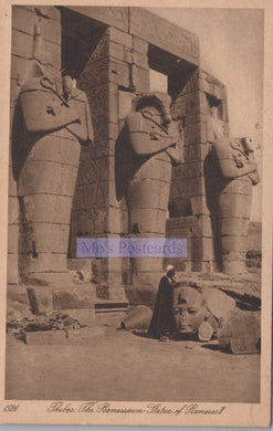 Vintage photograph of colossal statues at Ramesseum with a person for scale.