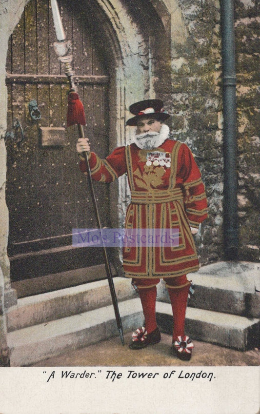 Man in a red and gold costume holding a staff, standing in front of a stone archway.