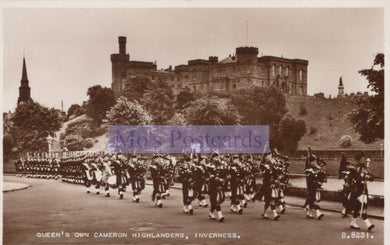 Vintage photograph of a military parade with soldiers in kilts in front of a castle.