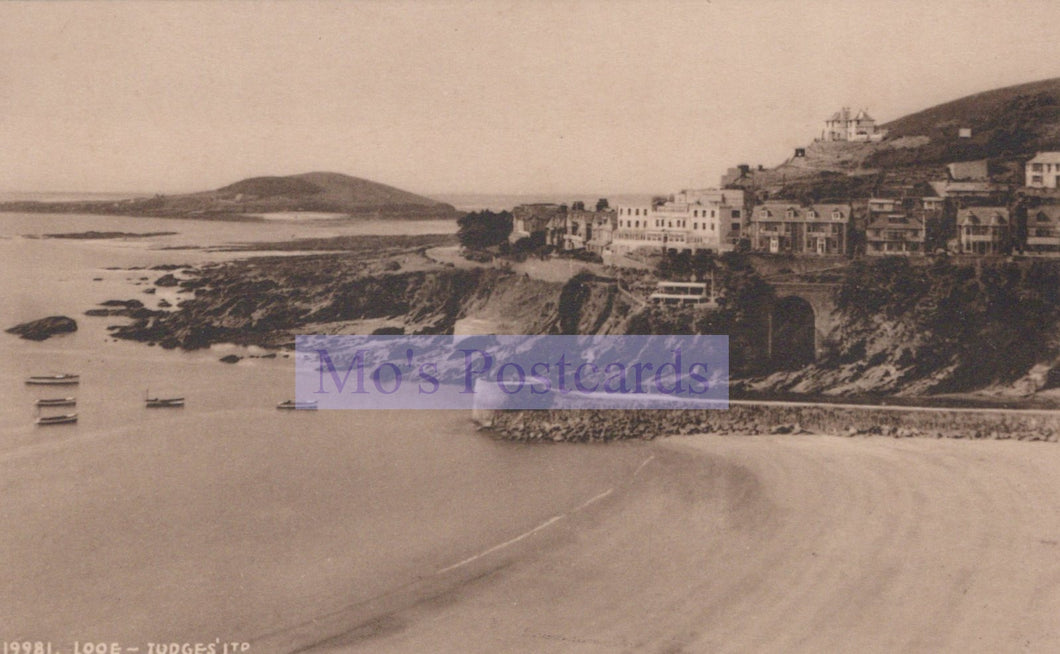 Vintage sepia-toned photograph of a coastal scene with buildings and boats.