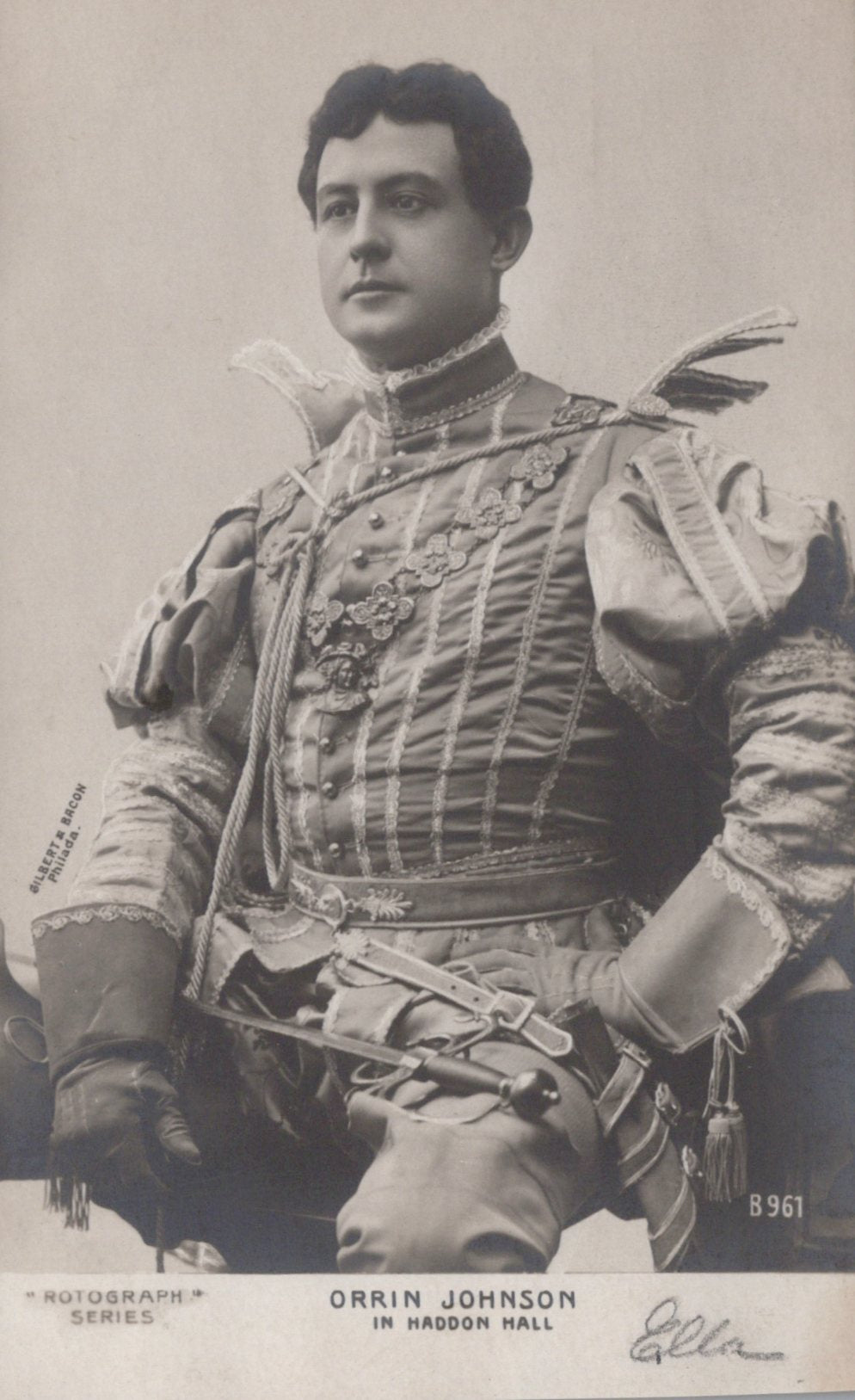 Vintage black and white photograph of a person in formal attire with decorative elements.