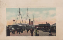 Load image into Gallery viewer, Vintage postcard of a dock scene with a large ship and people around.
