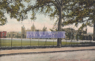 Vintage postcard of a castle-like building with trees and grass in the foreground.