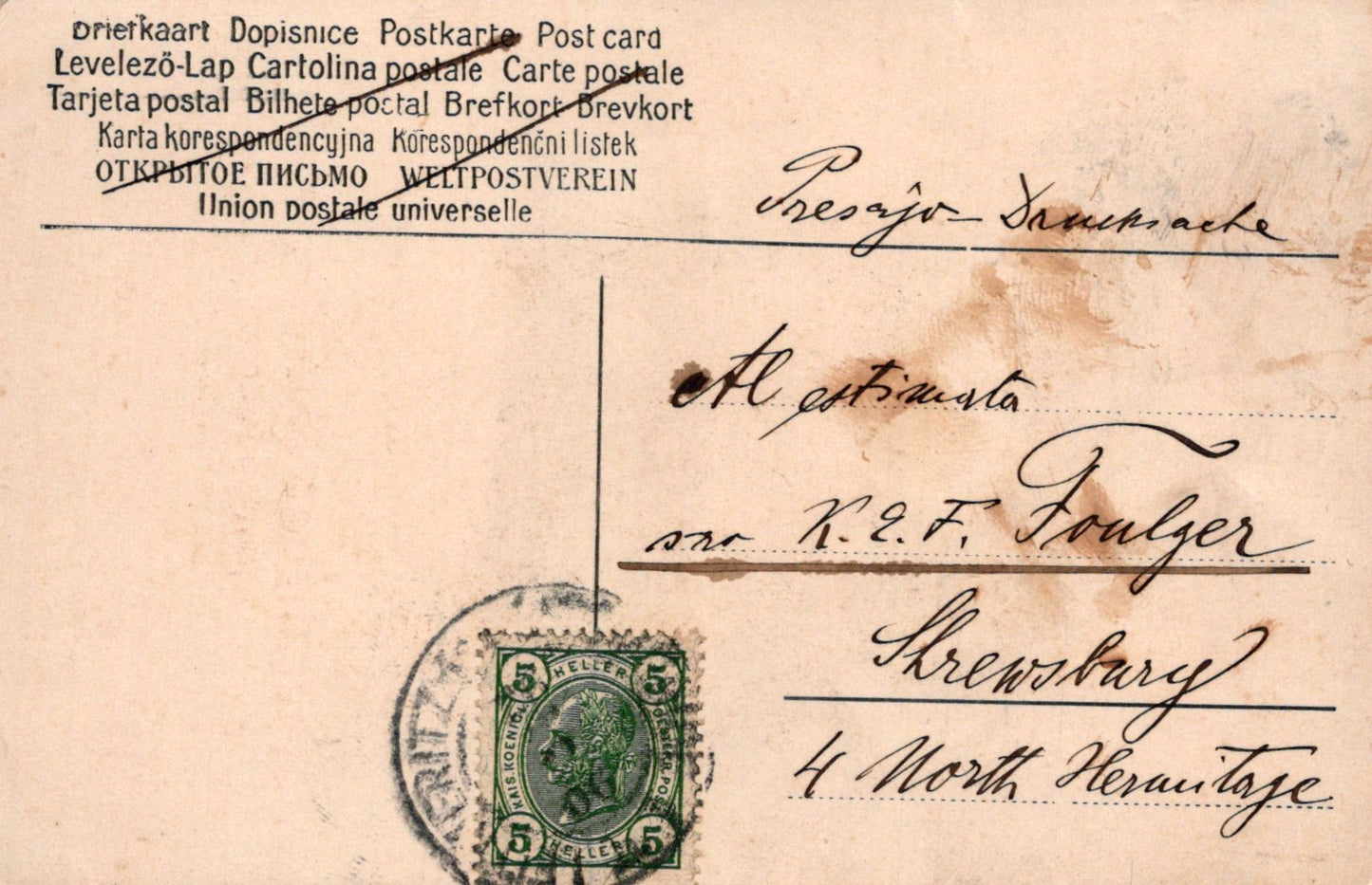 Vintage postcard with postage stamp and handwritten text on a beige background