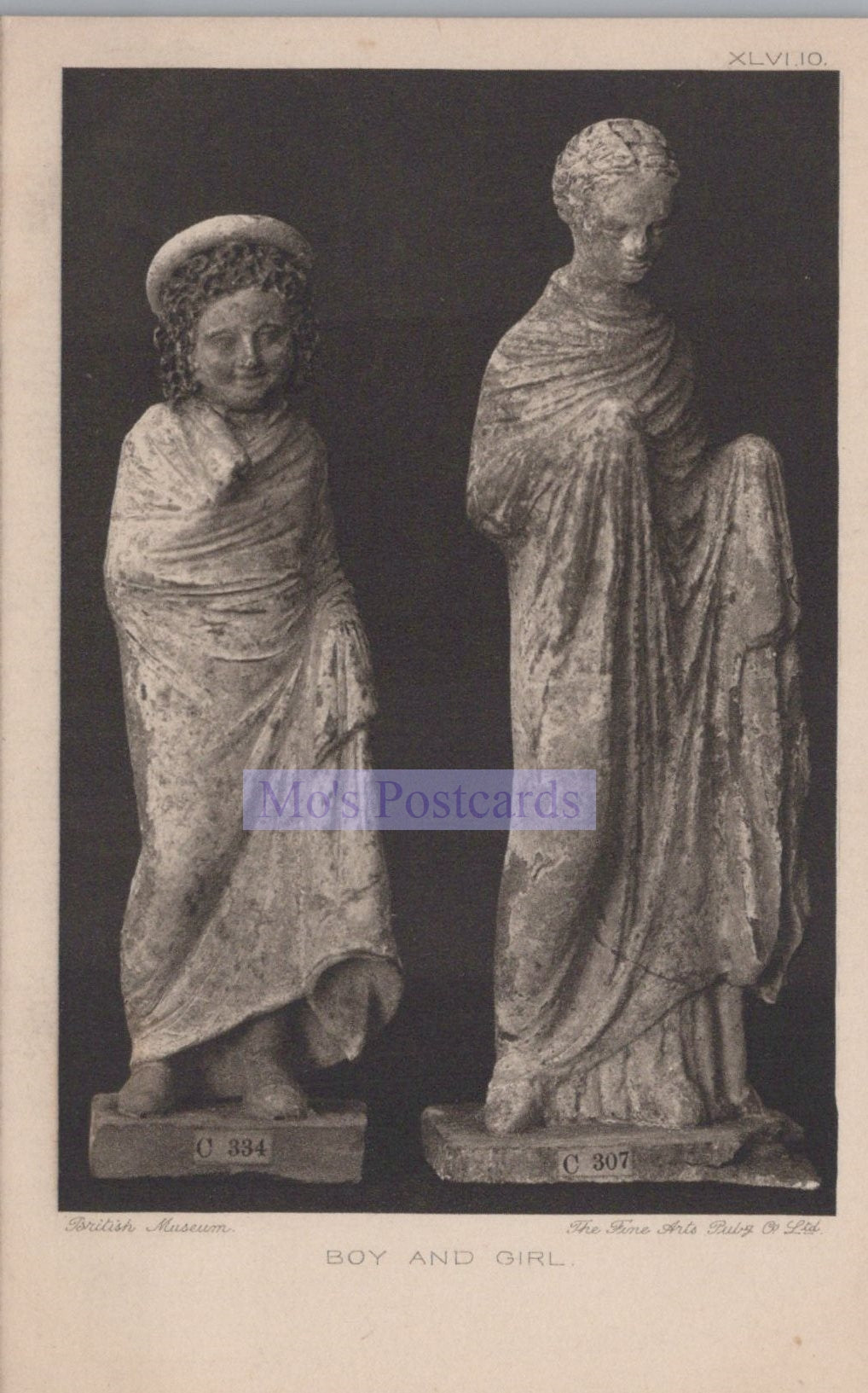 Two classical statues of a boy and a girl on a dark background
