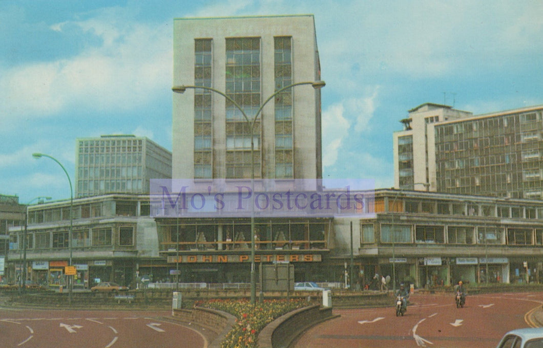Urban scene with modern buildings and a clear sky, featuring 'Mo's Postcards' watermark.