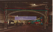 Load image into Gallery viewer, Decorative illuminated archway with colorful lights at night, featuring &#39;Mo&#39;s Postcards&#39; watermark.
