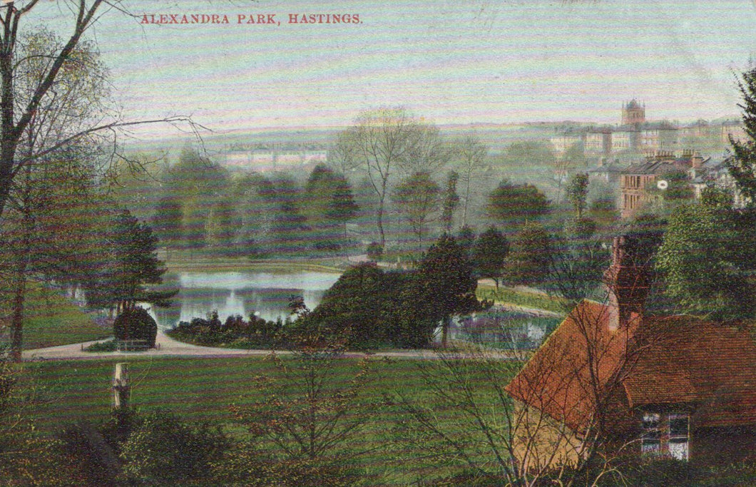 Vintage postcard of Alexandra Park, Hastings with a person looking towards the park.