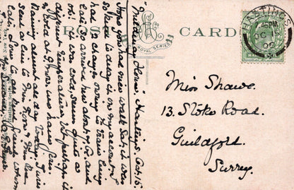 Vintage postcard with text and stamp, featuring a decorative design on the top left corner.