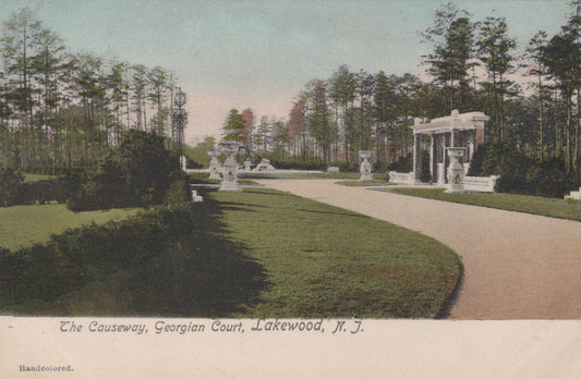 Vintage postcard of a garden scene with statues and pathways, labeled 'The Causeway, Georgian Court, Lakewood, N.J.'