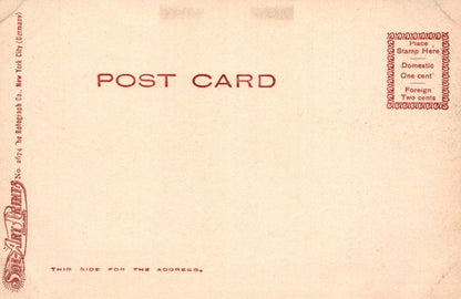 Back of a vintage postcard with red text and branding on a beige background