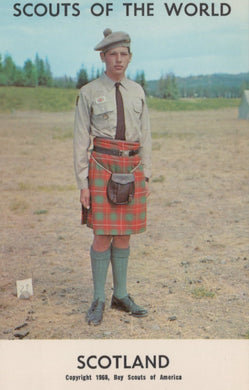 Scout in uniform with a kilt standing outdoors, with 'Scouts of the World' and 'Scotland' text at the top.