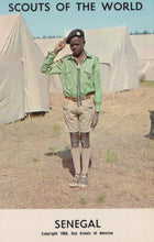 Load image into Gallery viewer, Scout in uniform standing in front of tents with &#39;Scouts of the World&#39; and &#39;Senegal&#39; text.
