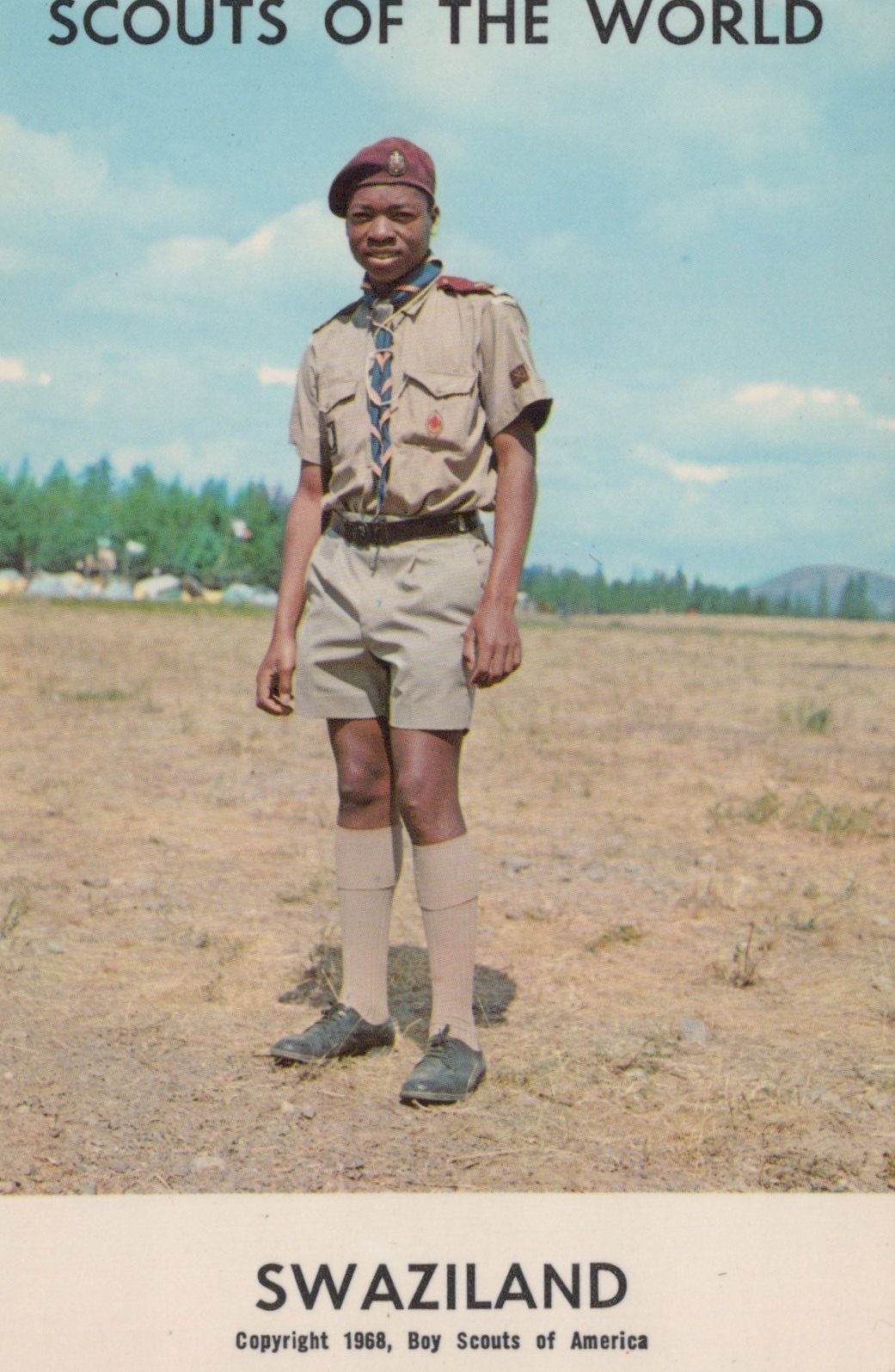 Scout in uniform standing outdoors with text 'Scouts of the World' and 'Swaziland'.