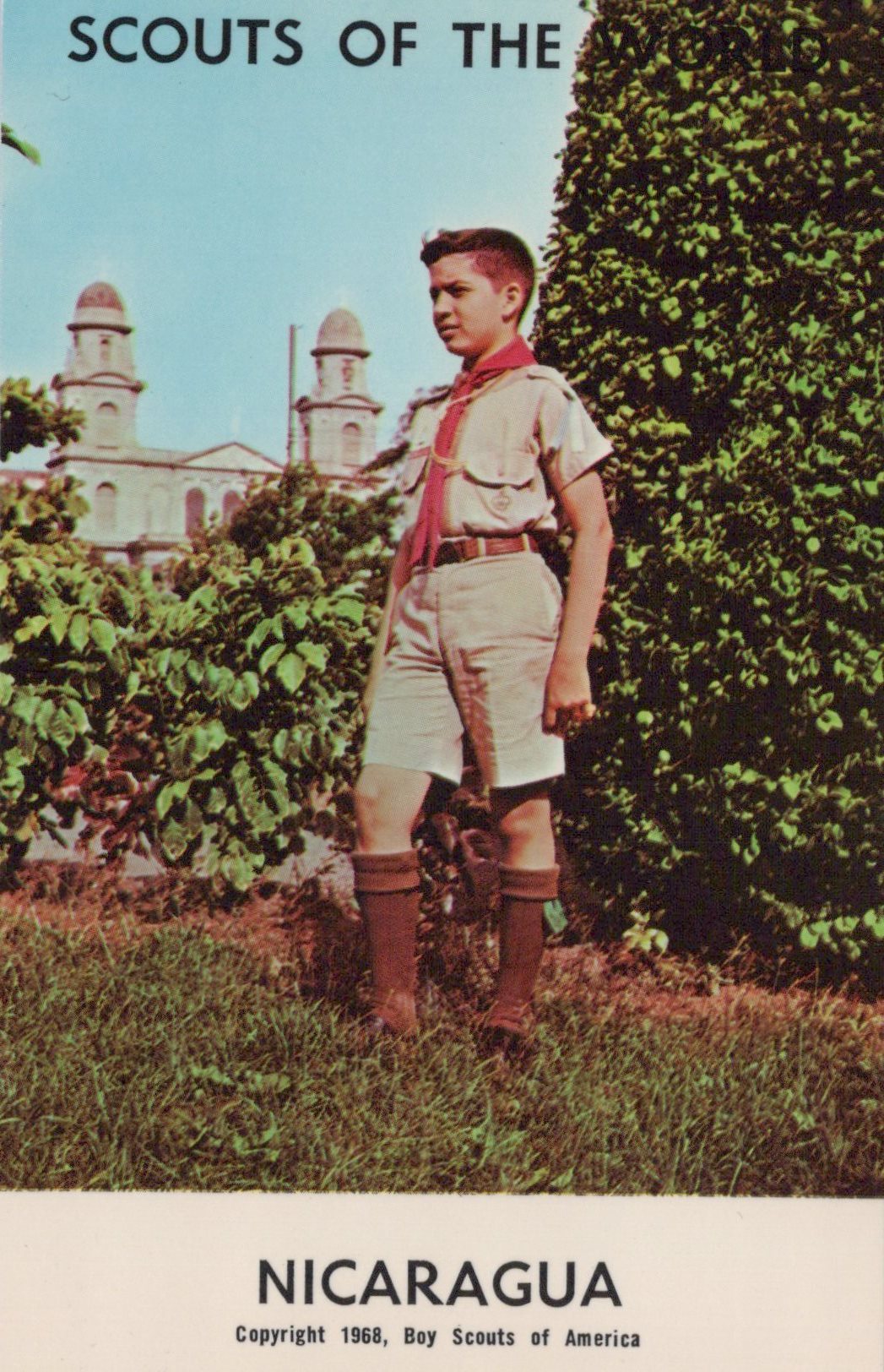 Scout standing outdoors with a building and trees in the background, labeled 'Scouts of the World, Nicaragua'.