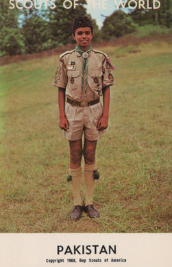 Scout in uniform standing in a field with 'Scouts of the World' and 'Pakistan' text at the top.