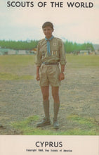 Load image into Gallery viewer, Scout in uniform standing outdoors with &#39;Scouts of the World&#39; and &#39;Cyprus&#39; text at the top.
