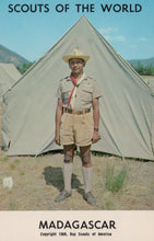 Load image into Gallery viewer, Scout in uniform standing in front of a tent with &#39;Scouts of the World&#39; and &#39;Madagascar&#39; text.
