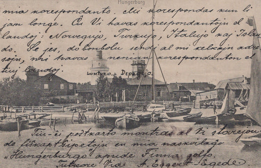 Vintage postcard with a scenic view of a harbor and handwritten text.