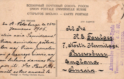 Vintage postcard with text and stamps, featuring a handwritten address.