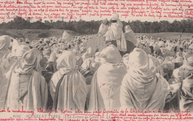 Vintage photograph of a large crowd of people wearing headscarves in a field.