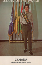 Load image into Gallery viewer, Scout standing in front of flags with &#39;Scouts of the World&#39; and &#39;Canada&#39; text.
