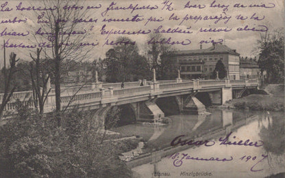 Vintage postcard of a bridge over a river with trees and buildings in the background