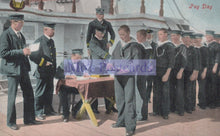 Load image into Gallery viewer, Vintage postcard of sailors on a ship with a man in uniform standing at a table.
