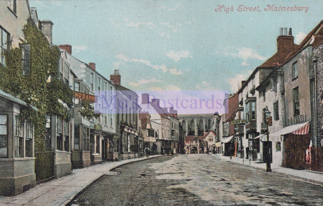 Vintage postcard of High Street in Malmesbury with shops and buildings on either side.