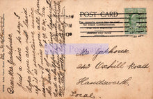 Load image into Gallery viewer, Vintage postcard with text and a stamp on a brown background
