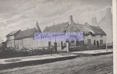 Vintage black and white photograph of a row of houses with a prominent sign in the center.